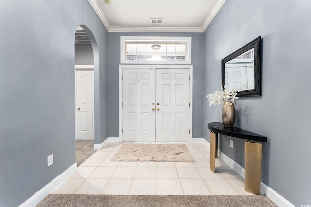 carpeted foyer entrance with crown molding