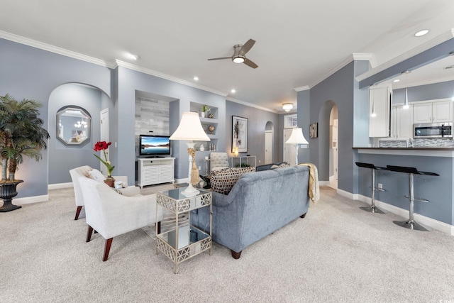 living room featuring light carpet, crown molding, and ceiling fan