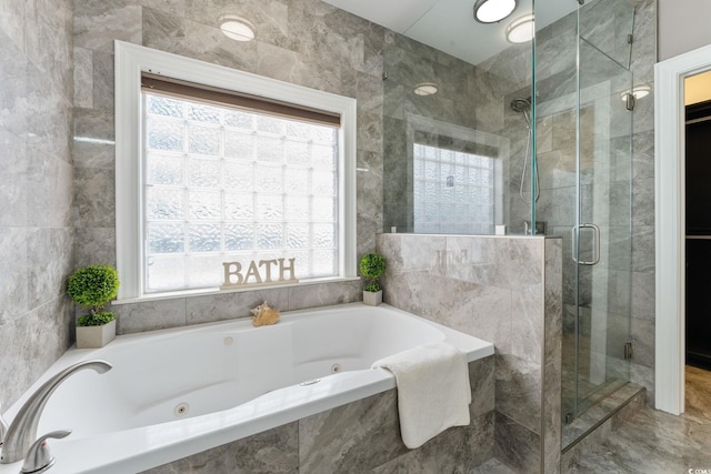 bathroom featuring independent shower and bath