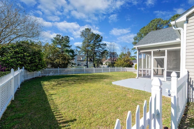 view of yard featuring a patio and a sunroom