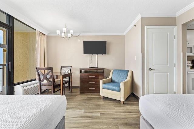 bedroom with a textured ceiling, hardwood / wood-style flooring, crown molding, and a notable chandelier