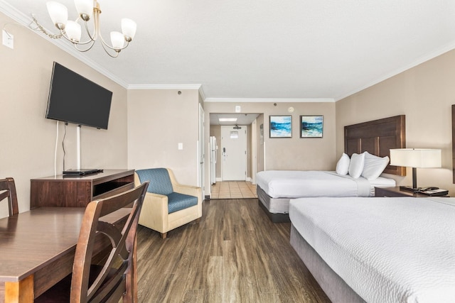 bedroom featuring a chandelier, dark hardwood / wood-style flooring, and crown molding