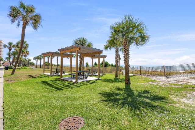 view of home's community featuring a pergola and a yard