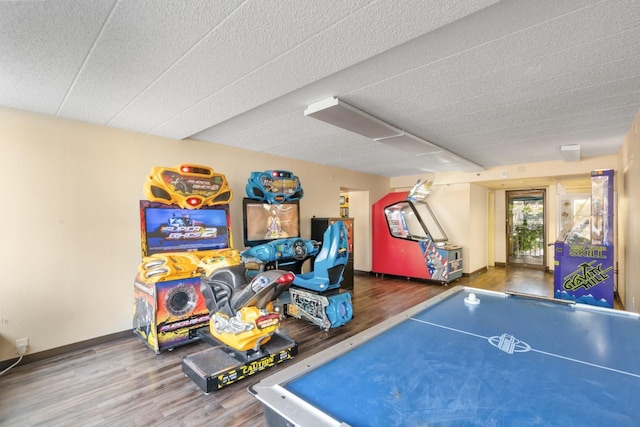 game room featuring hardwood / wood-style floors and a textured ceiling