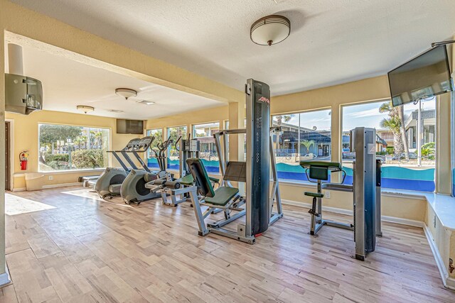 1207 S Ocean Blvd Unit 50606, Myrtle Beach, SC 29577 - exercise room with a textured ceiling and light wood-type flooring