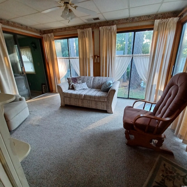 sunroom / solarium featuring ceiling fan and a drop ceiling