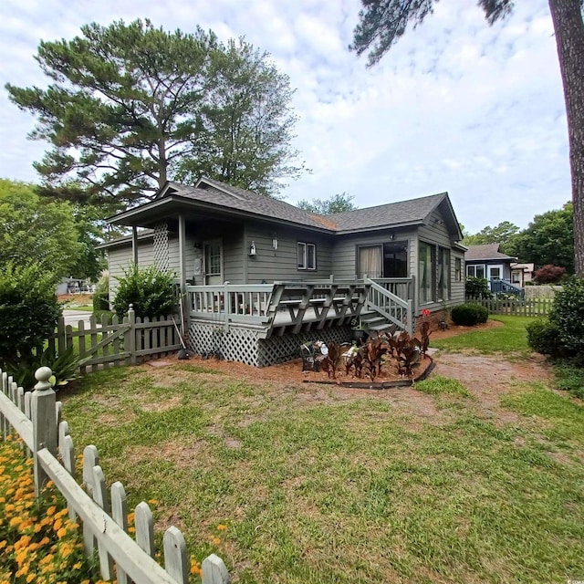 back of house featuring a yard and a deck