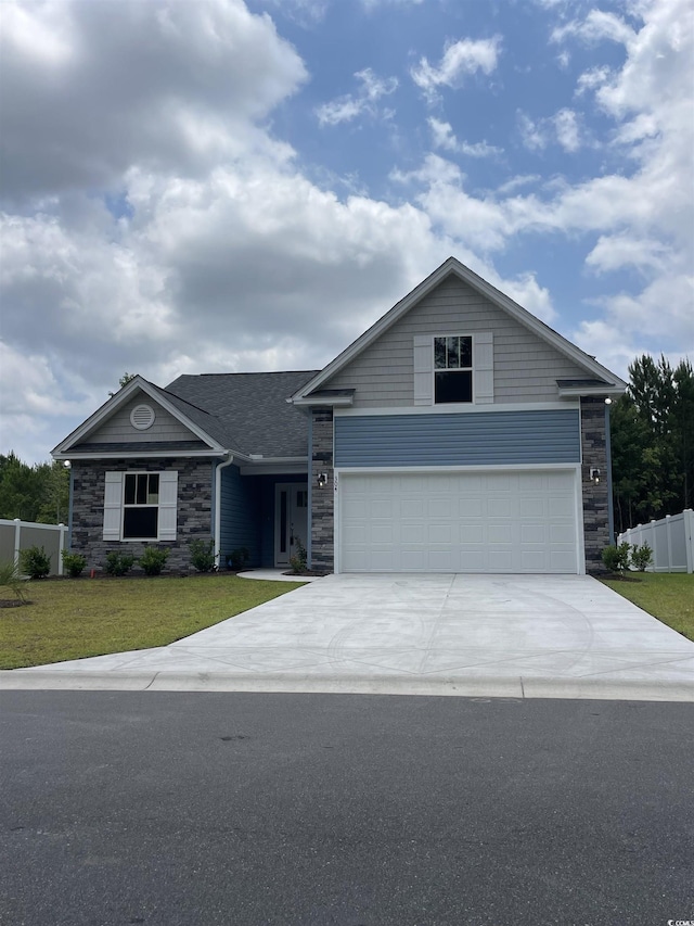 view of front facade with a garage and a front lawn