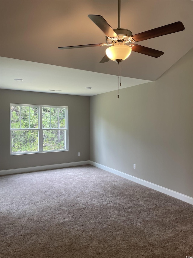 spare room featuring ceiling fan and carpet floors