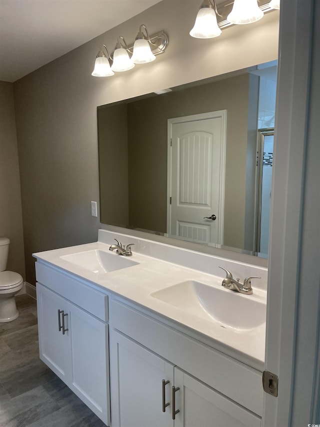 bathroom featuring hardwood / wood-style floors, vanity, and toilet