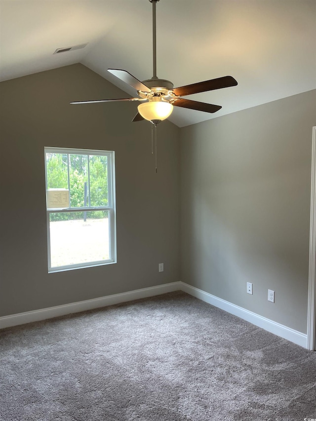 carpeted spare room featuring ceiling fan and lofted ceiling