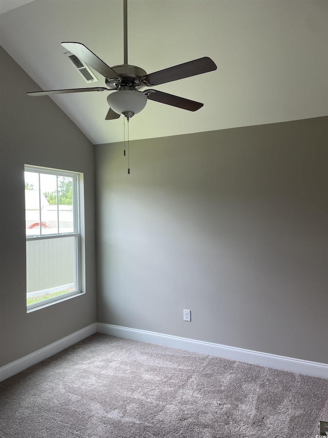 spare room with carpet, ceiling fan, and vaulted ceiling