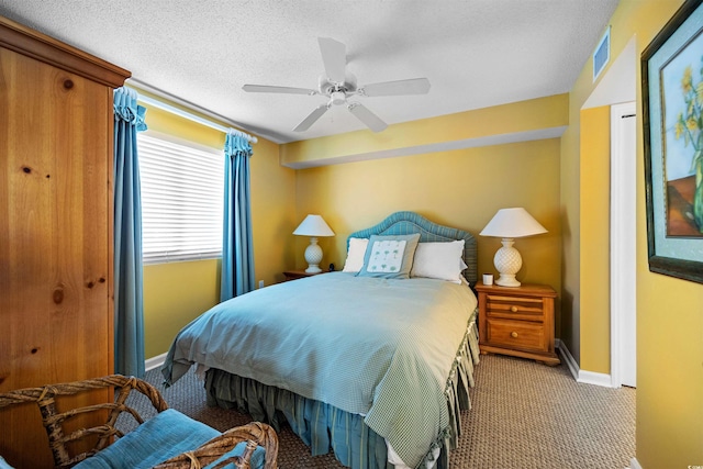 bedroom featuring a textured ceiling, carpet, and ceiling fan