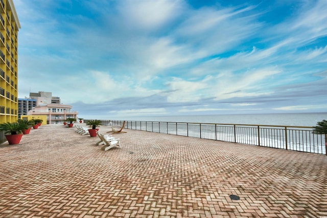 view of patio with a water view