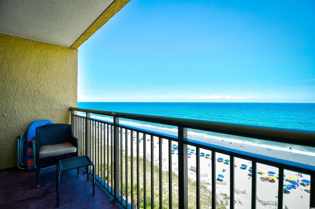 balcony with a beach view and a water view