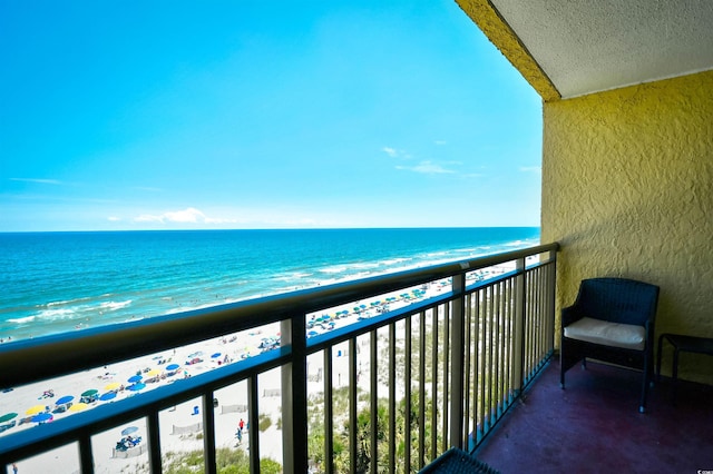 balcony with a water view and a beach view