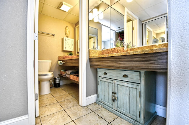 bathroom with toilet, tile patterned floors, and vanity