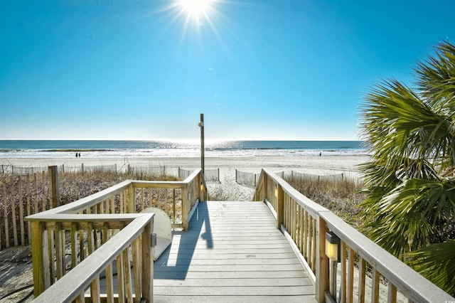 view of home's community with a water view and a view of the beach