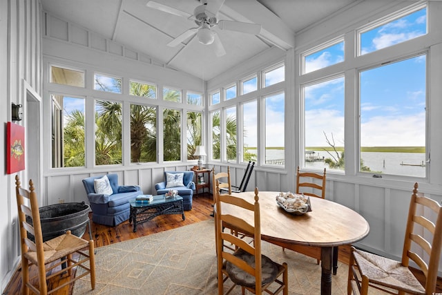 sunroom featuring vaulted ceiling with beams, a water view, and ceiling fan