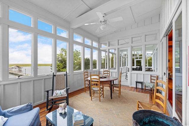 sunroom featuring lofted ceiling with beams, plenty of natural light, and ceiling fan