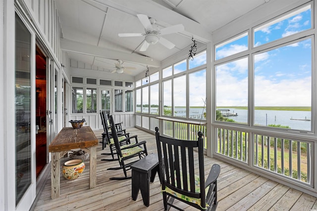 sunroom with beamed ceiling, a water view, and ceiling fan