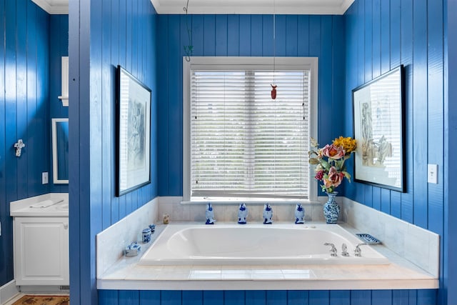 bathroom with wood walls, tiled tub, ornamental molding, and a healthy amount of sunlight