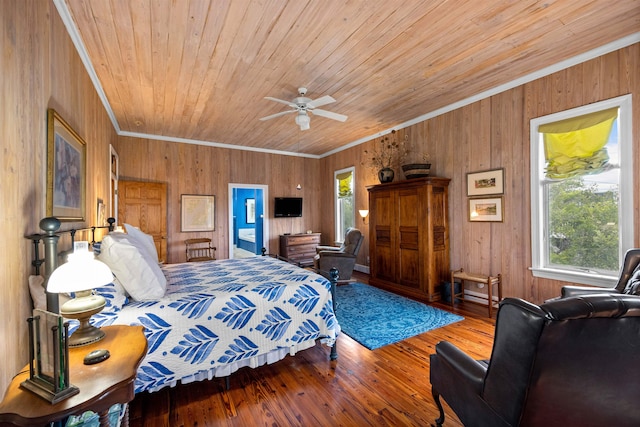 bedroom featuring wood walls, ornamental molding, wood-type flooring, and ceiling fan