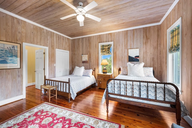 bedroom with wooden walls, wooden ceiling, hardwood / wood-style flooring, and ornamental molding