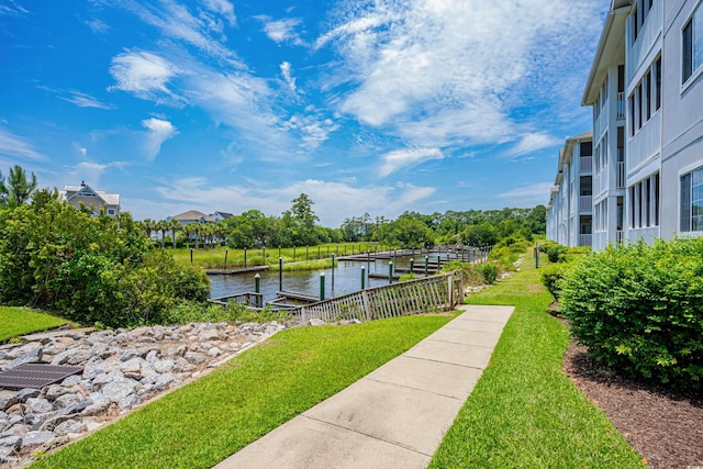 dock area featuring a yard and a water view