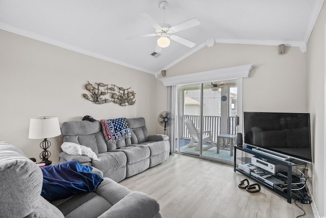 living room with crown molding, light hardwood / wood-style floors, and lofted ceiling