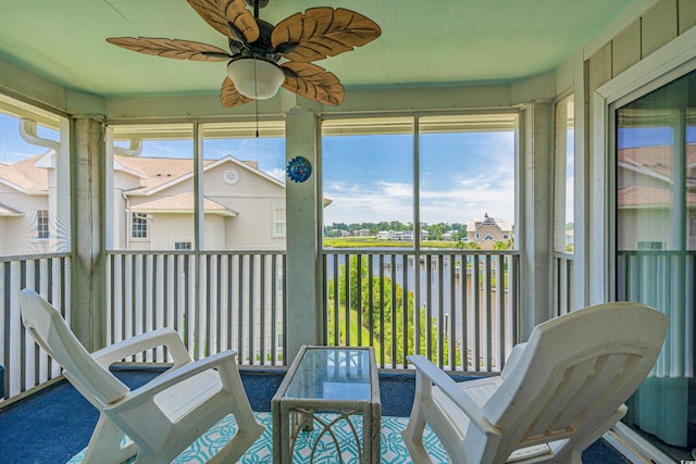 sunroom featuring ceiling fan and a healthy amount of sunlight