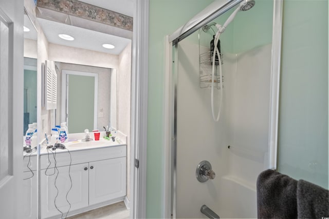 bathroom with vanity and combined bath / shower with glass door