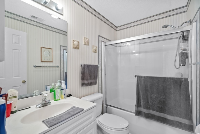 full bathroom with toilet, vanity, a textured ceiling, and combined bath / shower with glass door