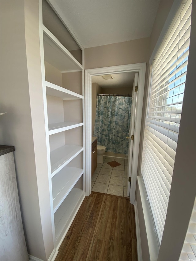 corridor featuring dark hardwood / wood-style floors