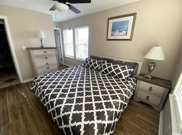 bedroom with dark hardwood / wood-style floors and ceiling fan