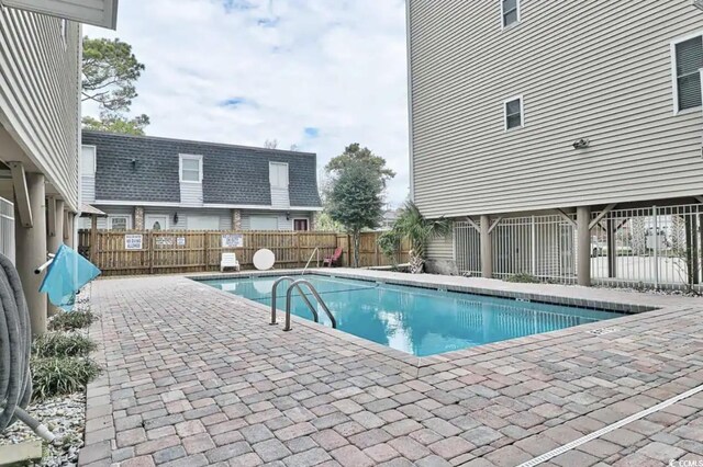 view of swimming pool with a patio