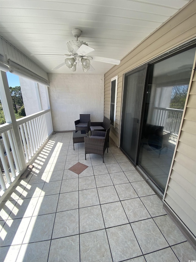 sunroom / solarium featuring ceiling fan