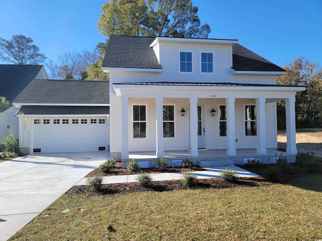 view of front facade with a porch, a garage, and a front lawn