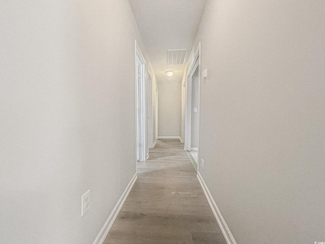 hallway with light hardwood / wood-style flooring