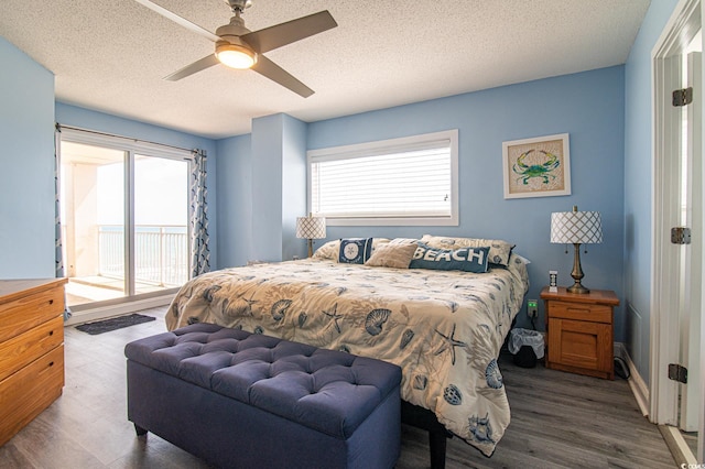 5800 N Ocean Blvd Unit 705, North Myrtle Beach, SC 29582 - bedroom with access to exterior, wood finished floors, ceiling fan, and a textured ceiling