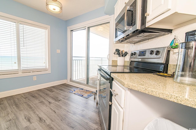 5800 N Ocean Blvd Unit 705, North Myrtle Beach, SC 29582 - kitchen with appliances with stainless steel finishes, healthy amount of natural light, decorative backsplash, and wood finished floors