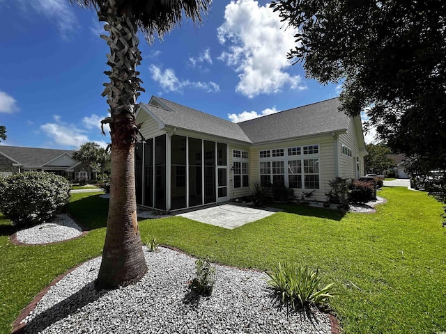 rear view of property with a sunroom and a lawn