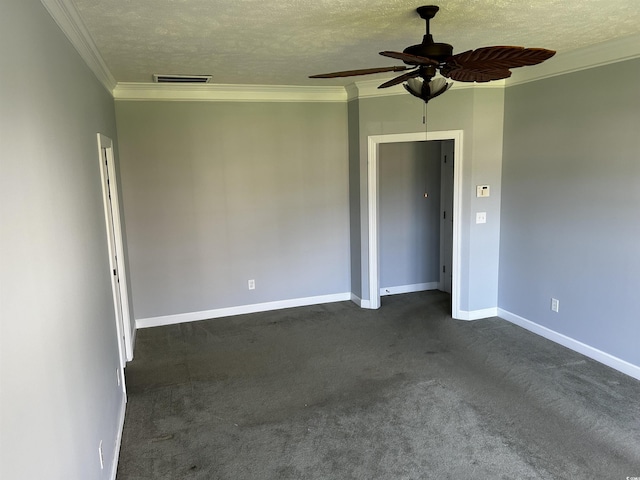 empty room featuring a textured ceiling, visible vents, and crown molding