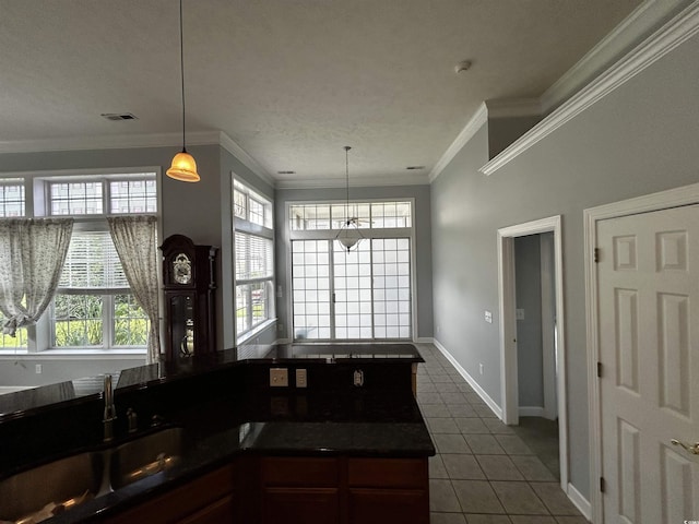 kitchen with tile patterned flooring, visible vents, crown molding, and dark countertops