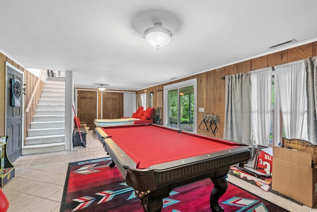 game room with pool table, light tile patterned floors, and wooden walls