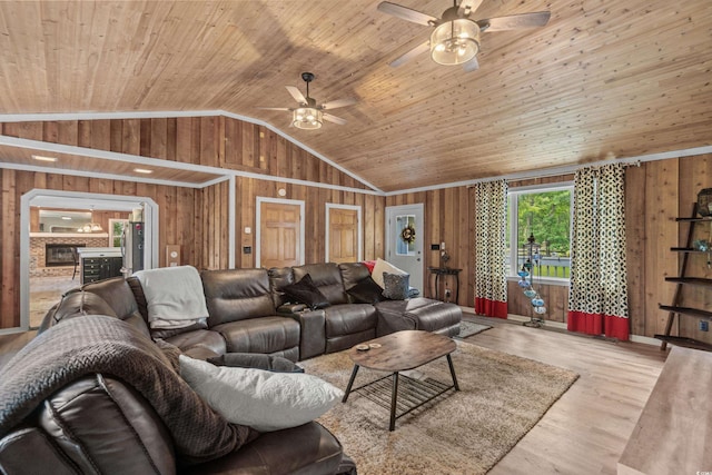 living room with wooden walls, wooden ceiling, and vaulted ceiling