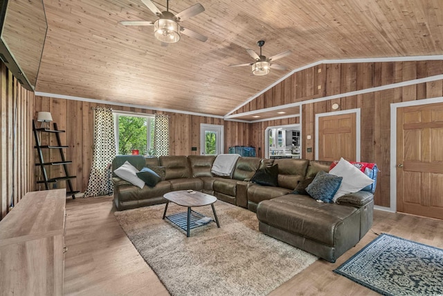 living room with lofted ceiling, wooden walls, and wooden ceiling