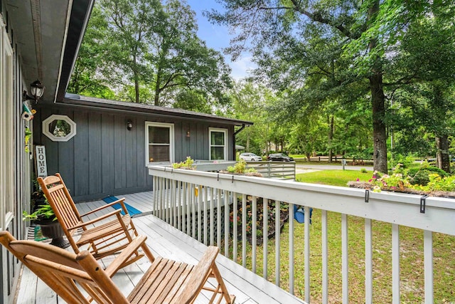 wooden terrace with a yard