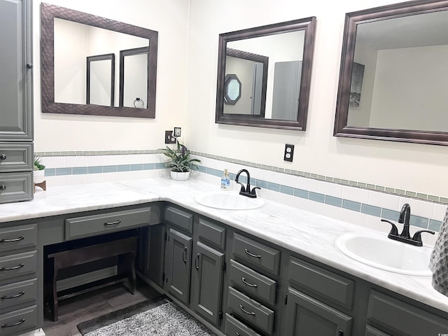 bathroom with vanity and decorative backsplash