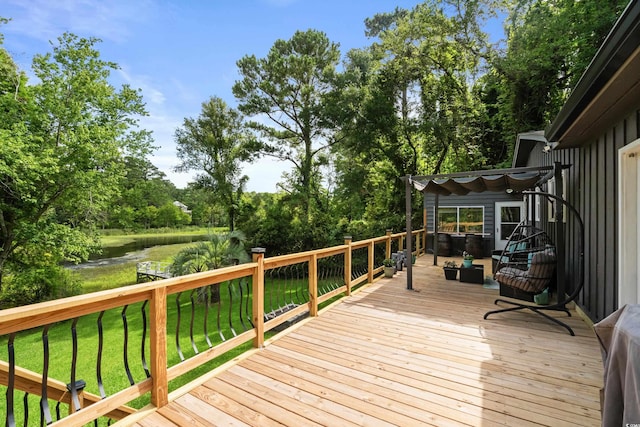 wooden deck with a lawn and a water view